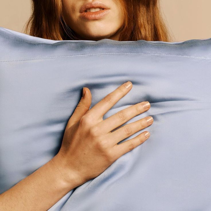 Close-up of a Pearl White silk pillowcase catching the light
