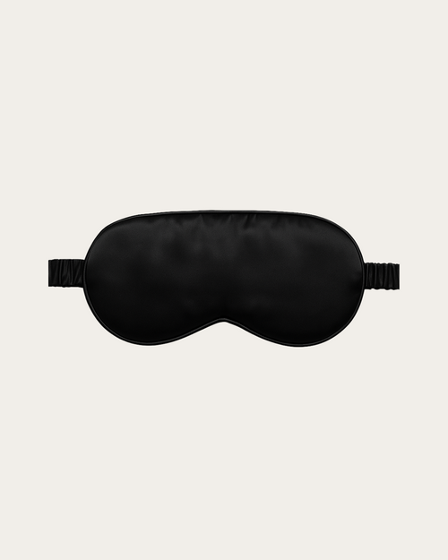 Obsidian Black silk sleep mask with a contoured eye shape and side elastic ties