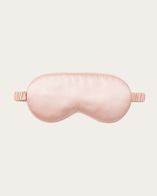 Blush Pink silk sleep mask with a curved eye cover and side elastic straps