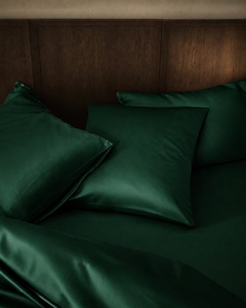 Emerald Green silk pillowcases on a bed with smooth folded covers