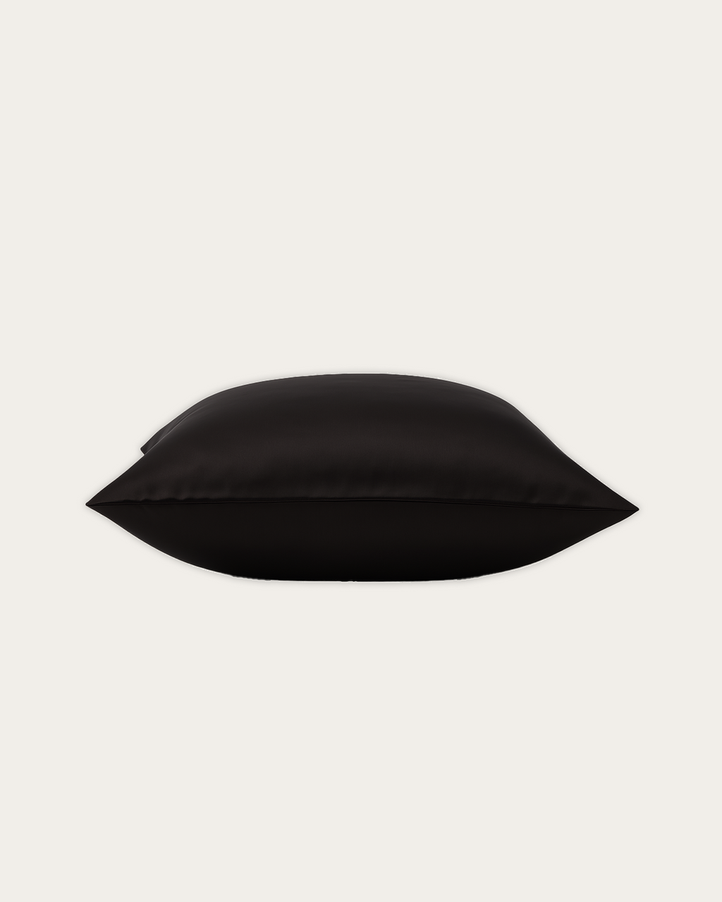 Close-up of Obsidian Black rectangle satin cushion cover showing soft sheen and refined Maison Veloura styling