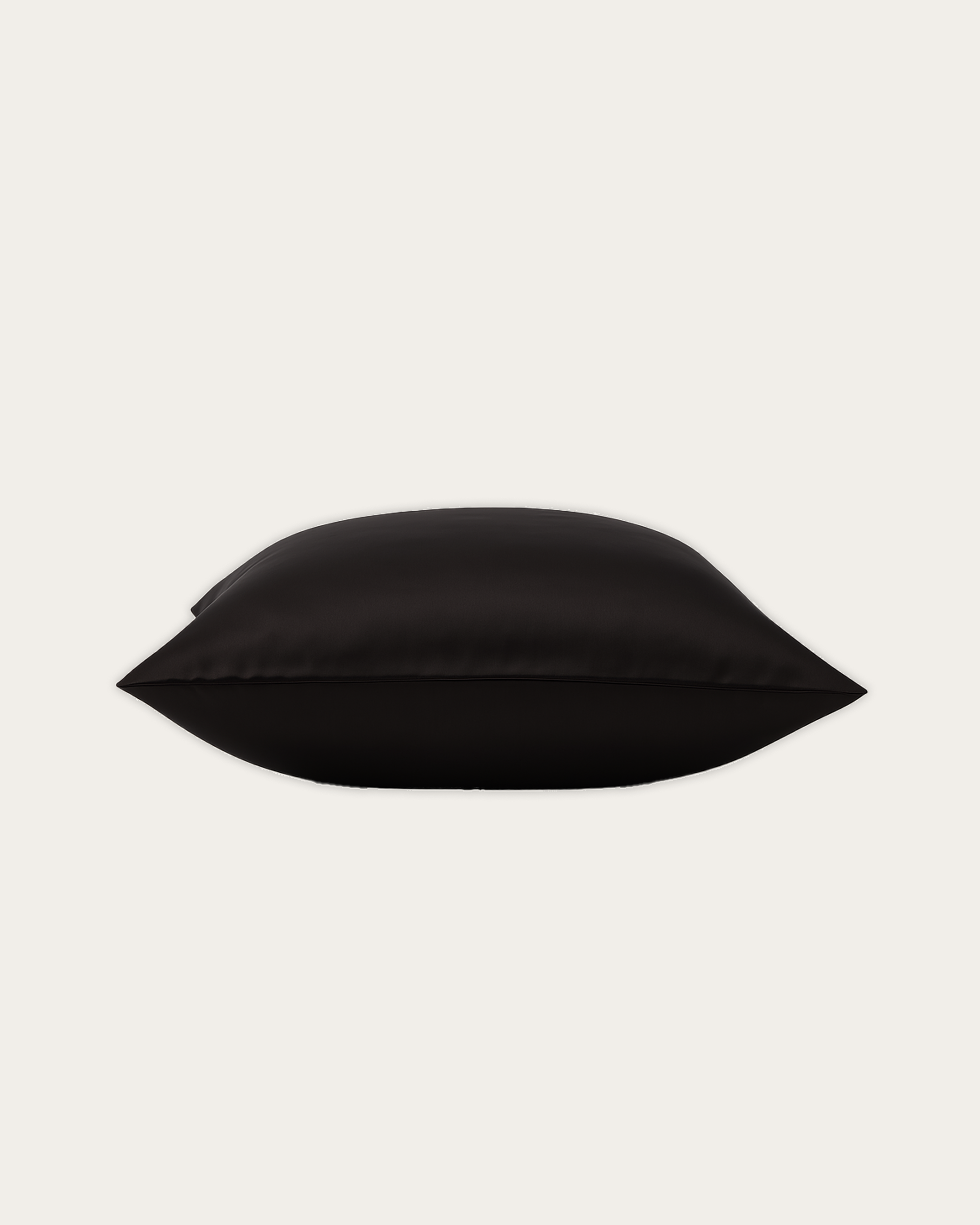 Close-up of Obsidian Black rectangle satin cushion cover showing soft sheen and refined Maison Veloura styling