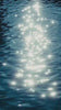 Sunlight shimmering on rippling blue water